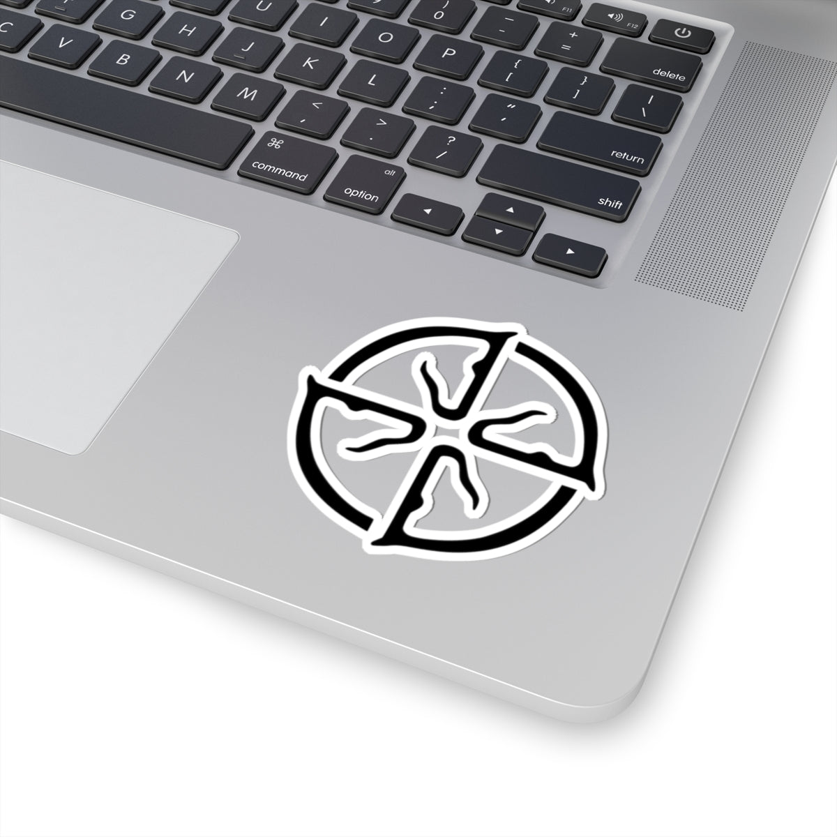 Laptop with a black and white circular sticker on the palm rest area