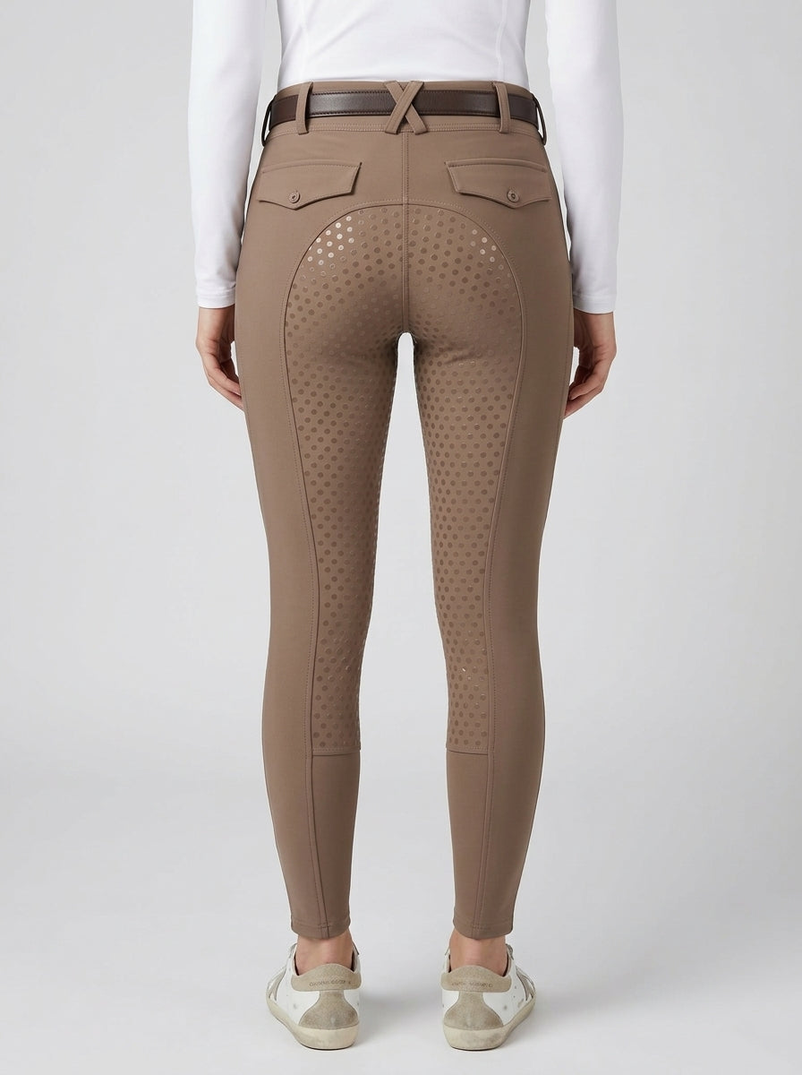 Brown riding pants with a textured pattern worn by a person on a white background