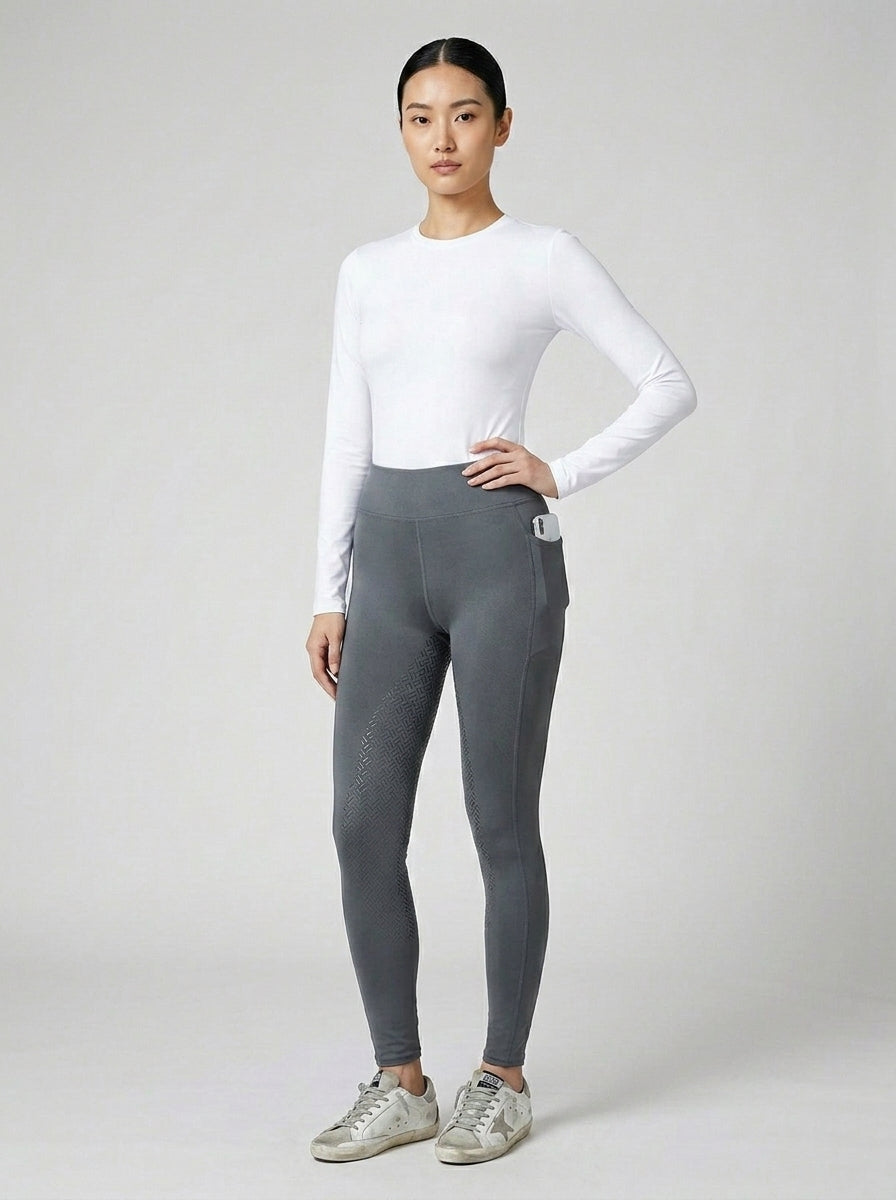 Women's grey full-seat riding tights with silicone grip panel, white base layer and Golden Goose sneakers, front view

