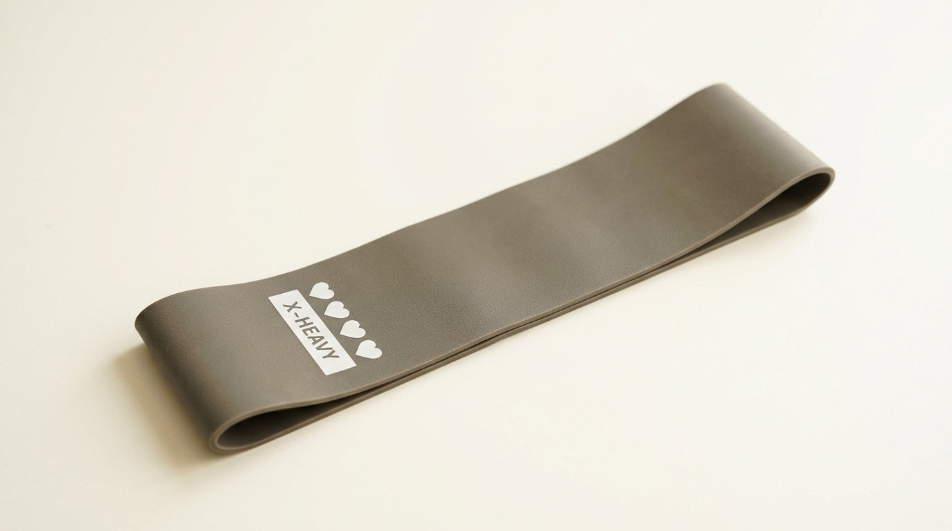 Single flat loop resistance band in grey on a neutral background — Notting Hill Equine Rider Fitness