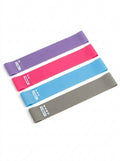 Set of resistance bands in purple, pink, blue, and gray on a white background
