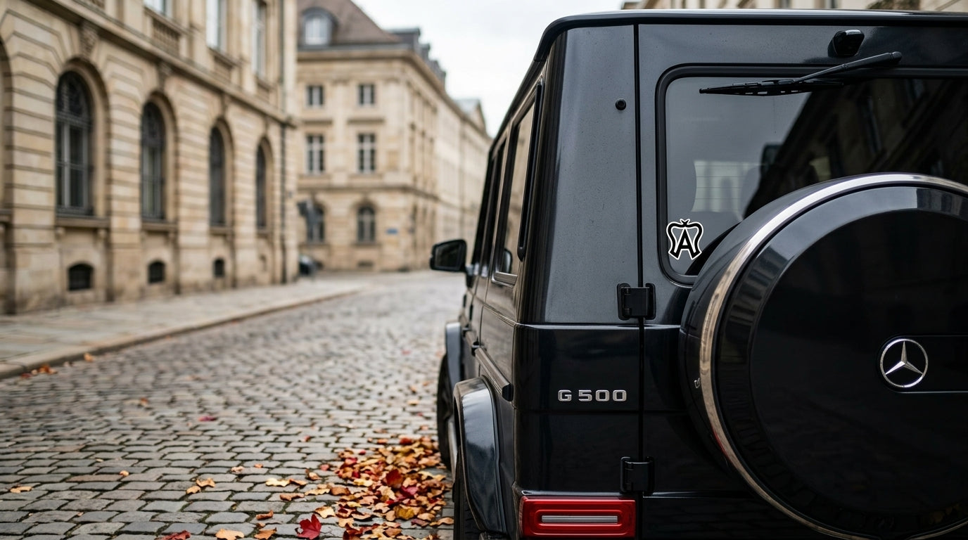 American warmblood registry vinyl sticker on a black Mercedes G-Wagon window on a cobblestone European street, warmblood breed sticker decal