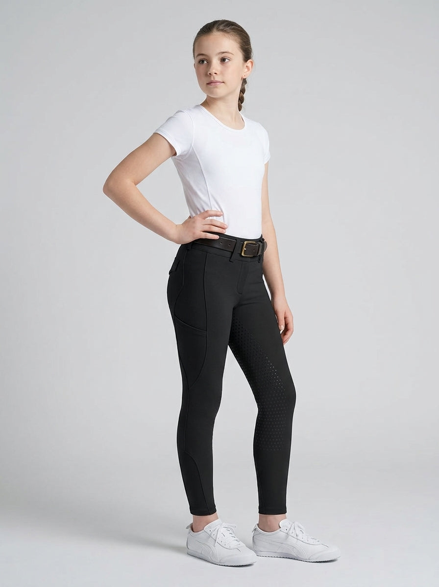 Person wearing black riding pants and a white top on a gray background