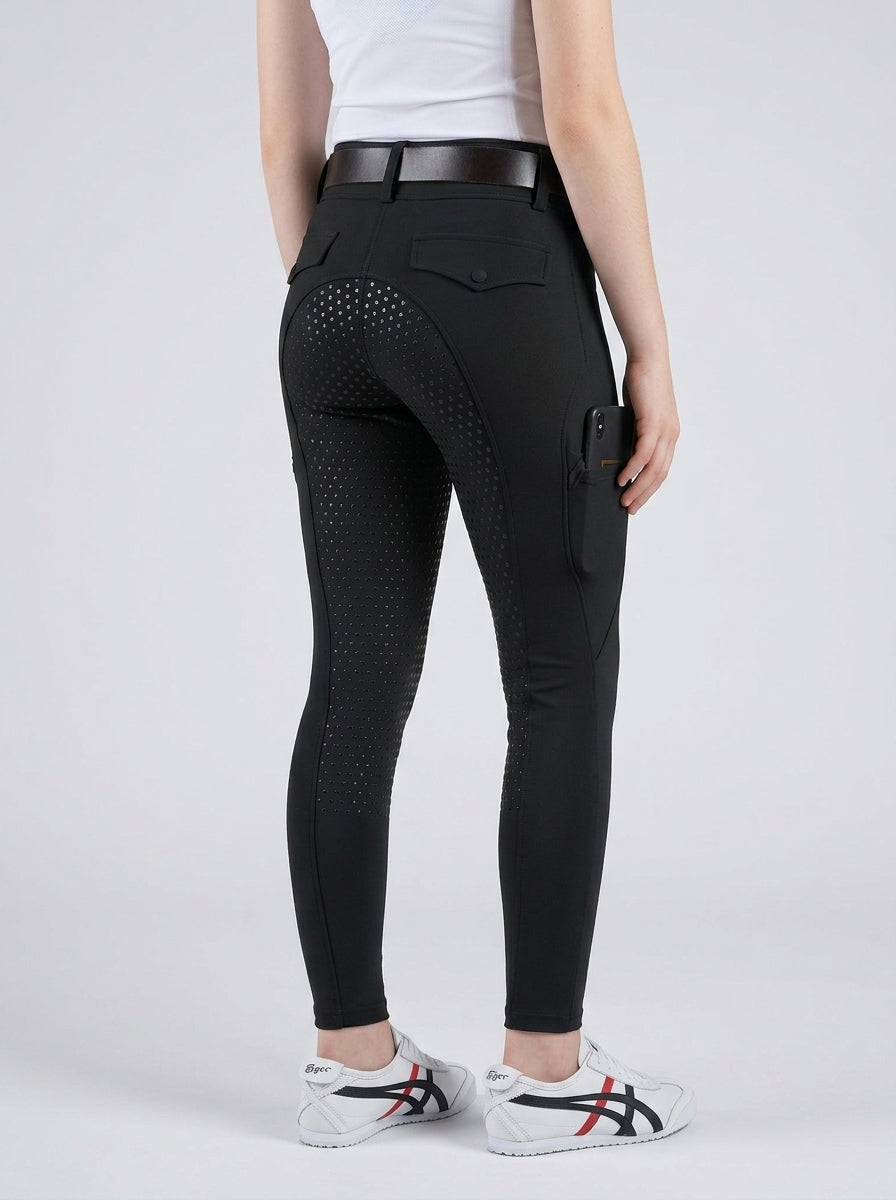 Person wearing black riding pants on a white background