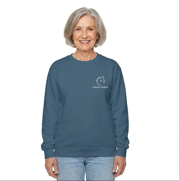 Woman wearing a blue sweatshirt with a logo on a white background