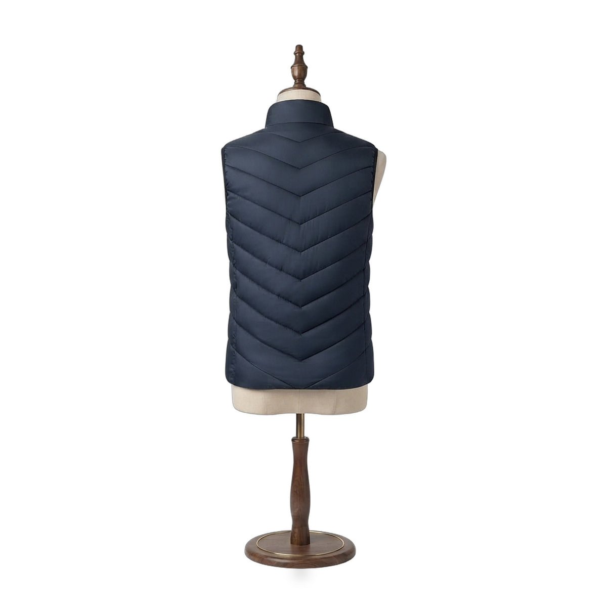 The Warm Up Heated Vest in Dusk navy, back view showing chevron quilting on a beige dress form