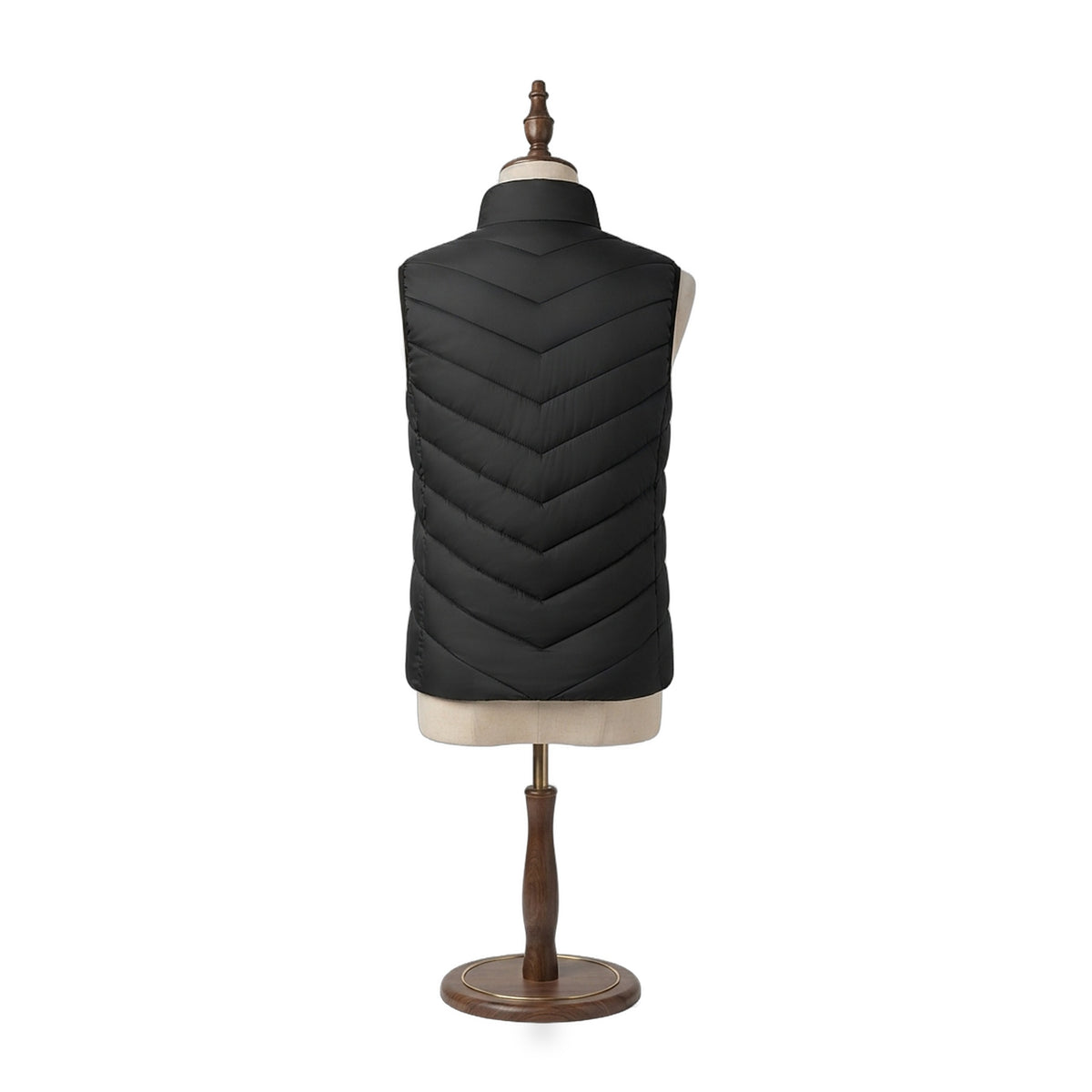 The Warm Up Heated Vest in Midnight black, back view showing chevron quilting on a beige dress form